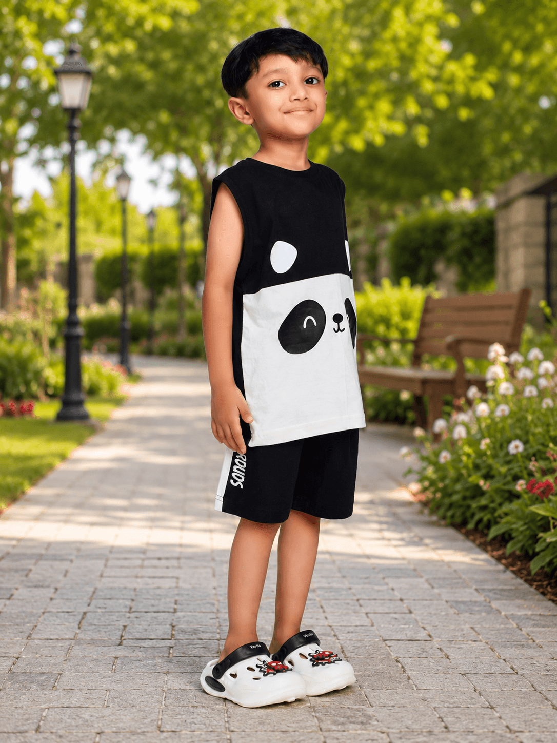PANDA POP SLEEVELESS CO-ORD FOR BOYS GIRLS BLACK WHITE worn by a boy in a park, featuring a cute panda design.