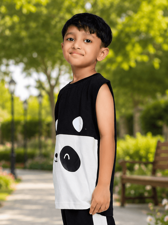 PANDA POP SLEEVELESS T-SHIRT FOR BOYS GIRLS BLACK WHITE worn by a smiling boy outdoors in a park.