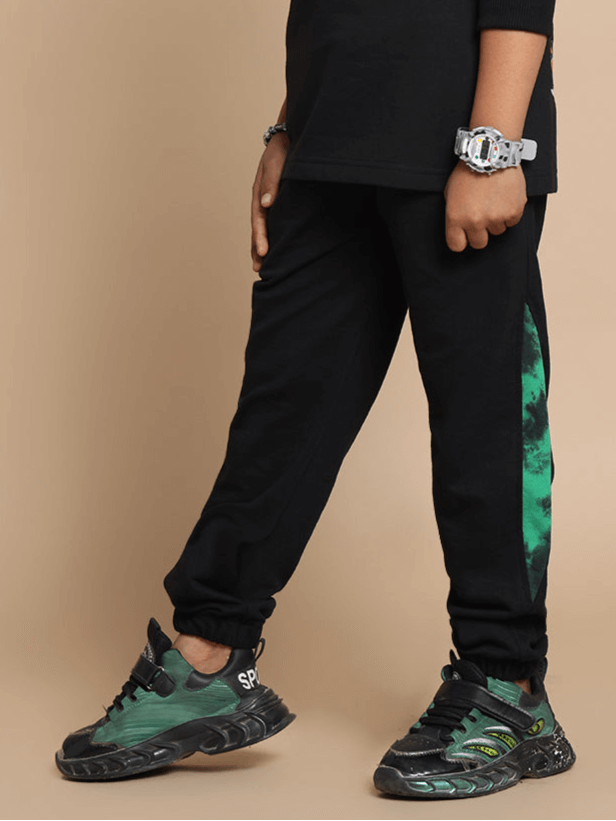 Child wearing black Panda Co-ord with green accents, designed for both boys and girls by DUDS.
