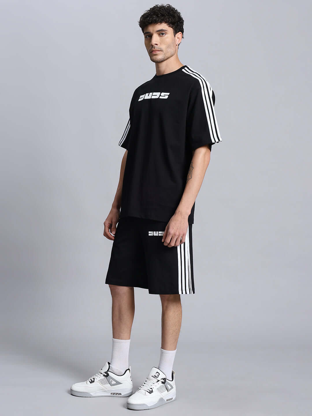 Model wearing PARKA SUMMER COTTON CO-ORD SET BLACK with stripes, showcasing casual comfort and style in a relaxed fit with sneakers.