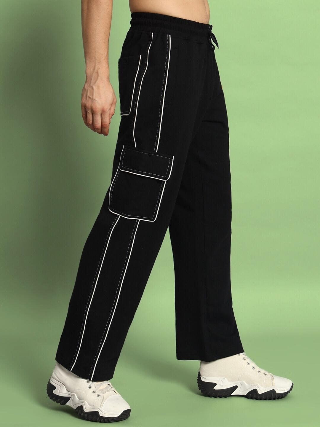 Side view of black pedal contrast stitch cargo pants with white sneakers, showcasing design and craftsmanship by DUDS Tailors.