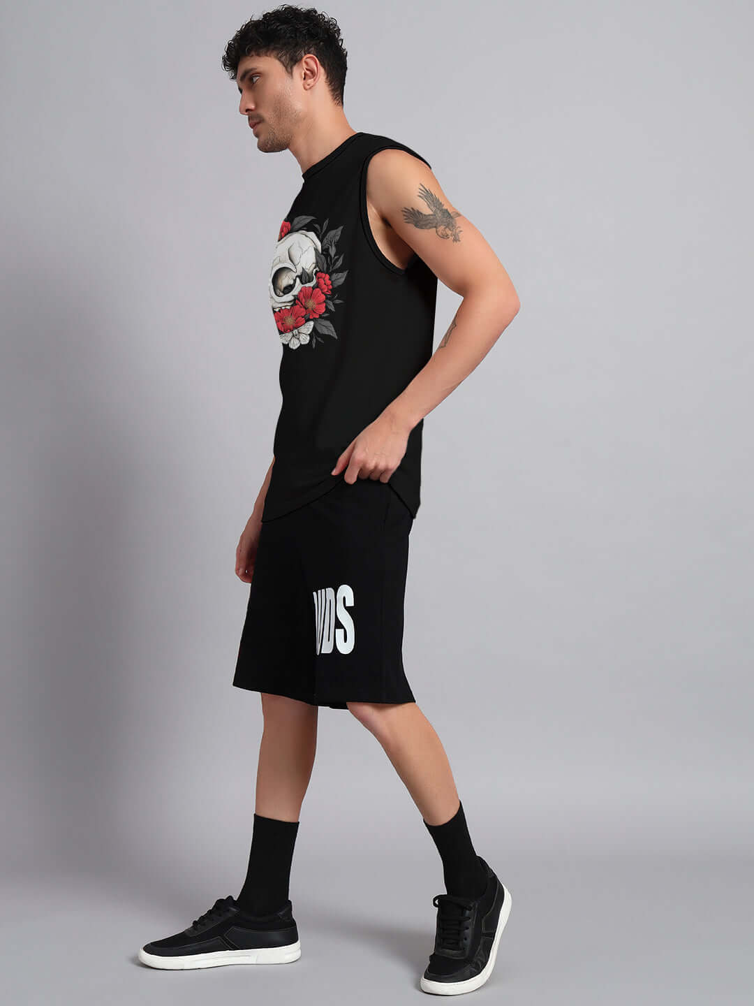 Model wearing black Peonies Skull Co-ord Set with sleeveless top and shorts, showcasing floral skull design, by Color By.