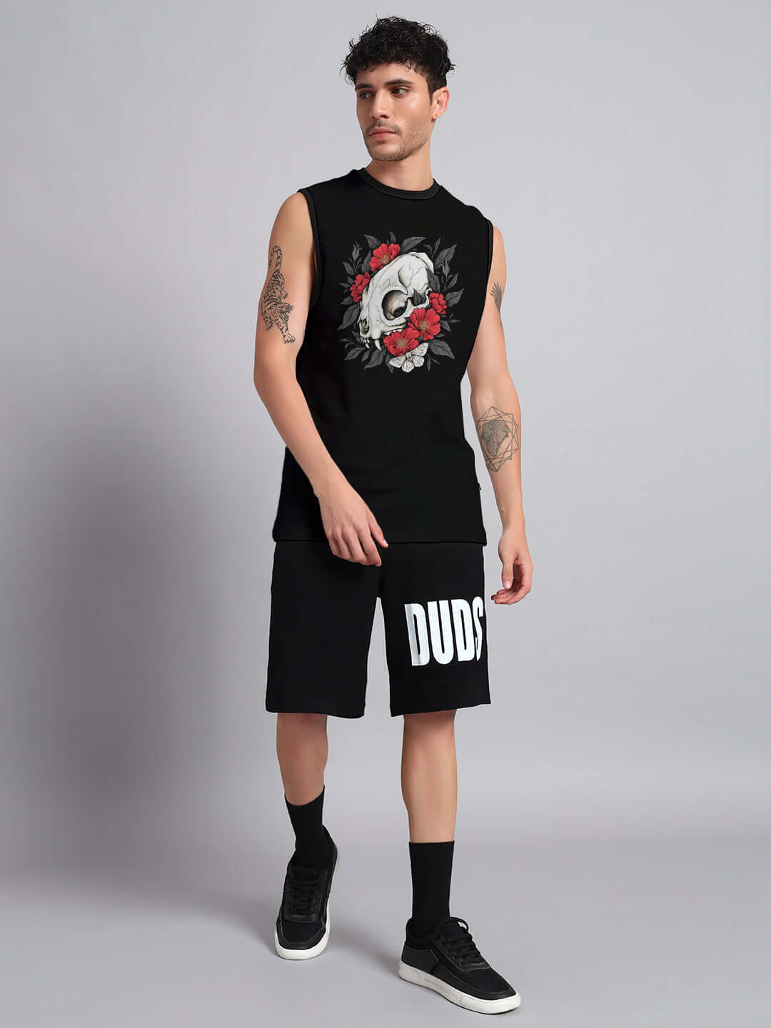 Model wearing PEONIES SKULL CO-ORD SET BLACK with skull and peony design, showcasing edgy streetwear style against a sleek black backdrop.