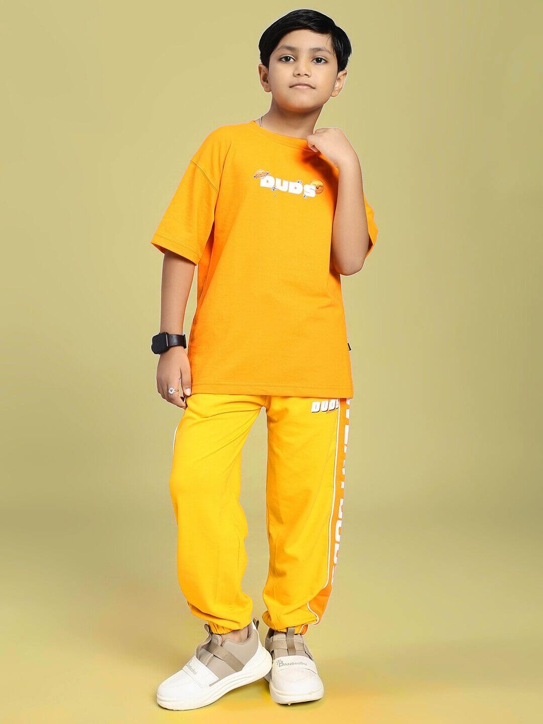 Child wearing PEPPY JOGGER FOR BOYS AND GIRLS ORANGE, demonstrating style and comfort with vibrant color and relaxed fit.