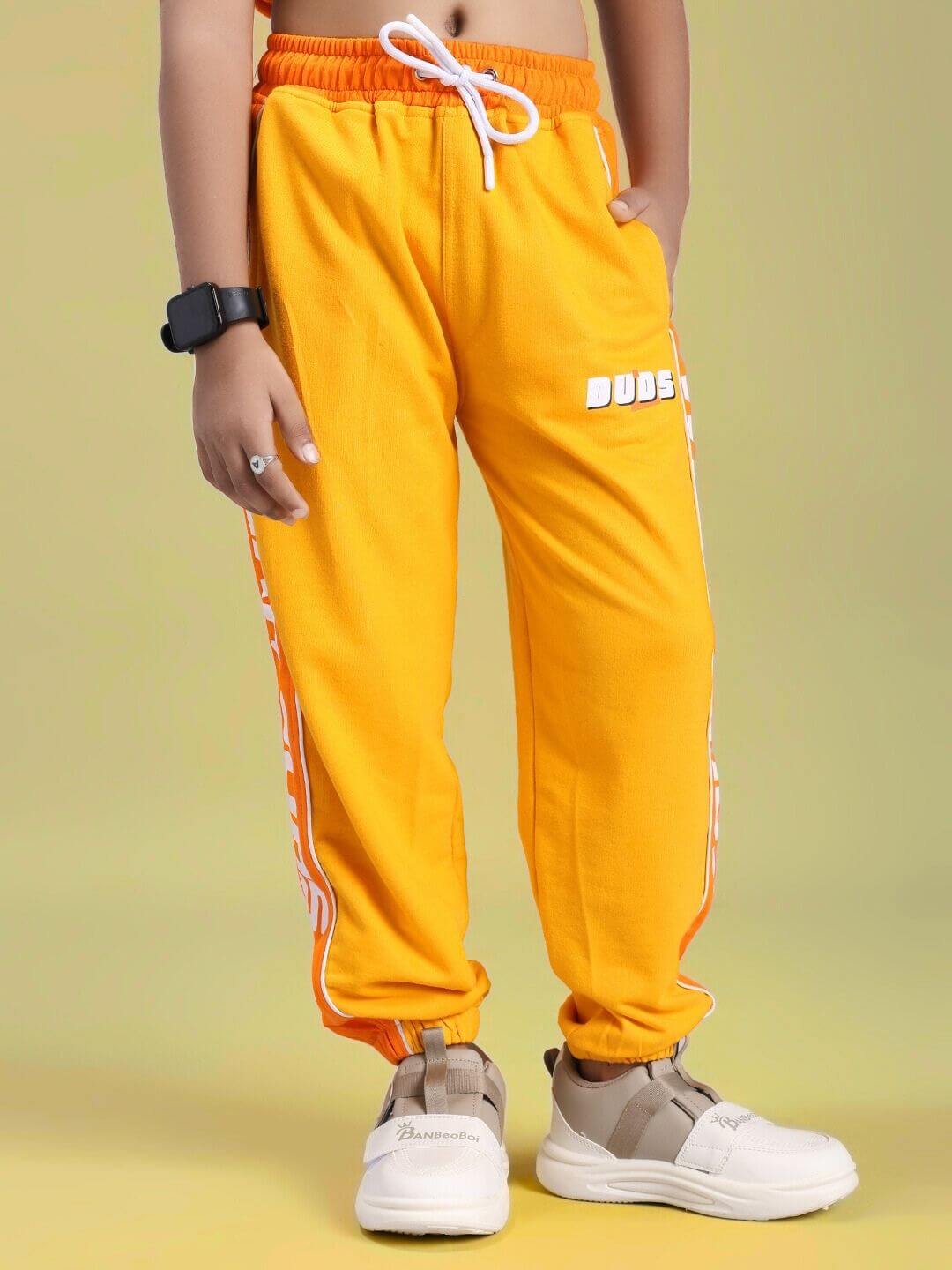 Child wearing PEPPY JOGGER FOR BOYS AND GIRLS ORANGE showing vibrant style and comfort.