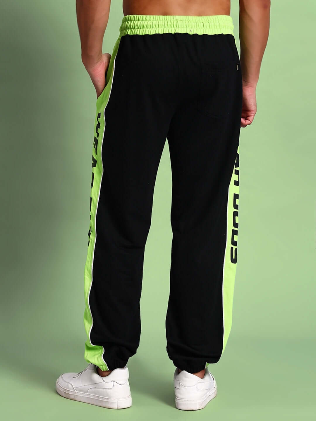 Model wearing Peppy Joggers in black and neon green, featuring custom fit and made-to-order tailoring by DUDS.