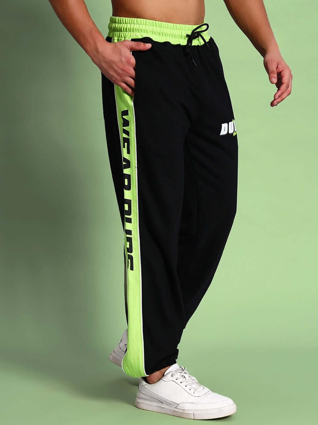 Person wearing black-neon green Peppy Joggers with "Wear DUDS" text, showcasing comfort and style. Custom fit available.