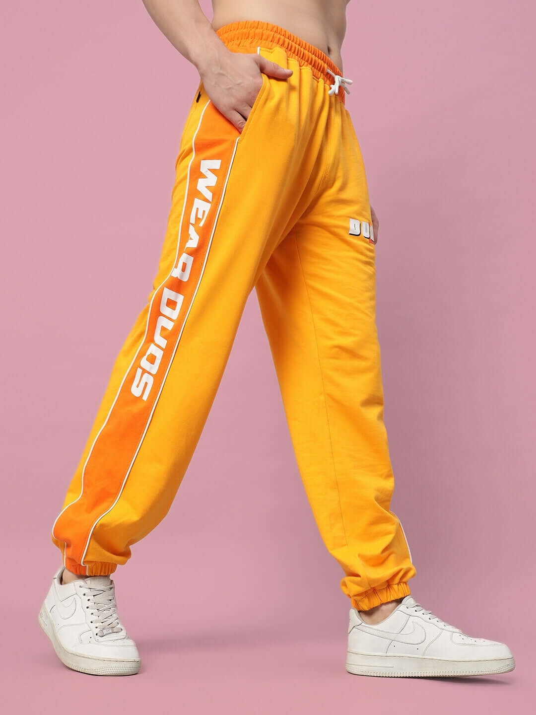 Peppy Joggers in vibrant yellow-orange with 'Wear Duds' lettering, tailored fit shown, perfect for casual wear.