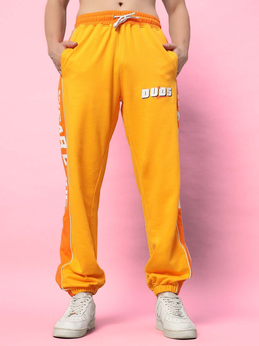 Yellow-orange Peppy Joggers by DUDS, shown on a model, featuring comfortable fit and custom size options for personalized style.