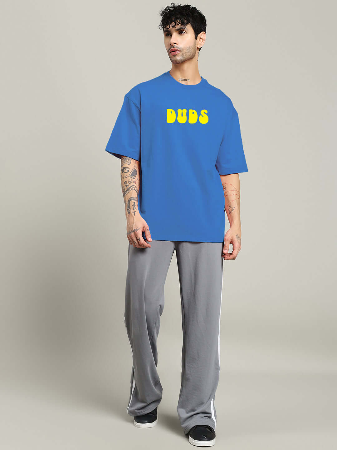 Model wearing PERSONAL TRUTH OVERSIZED T-SHIRT BLUE with 'BUDS' text, showcasing the relaxed fit ideal for streetwear fashion enthusiasts.