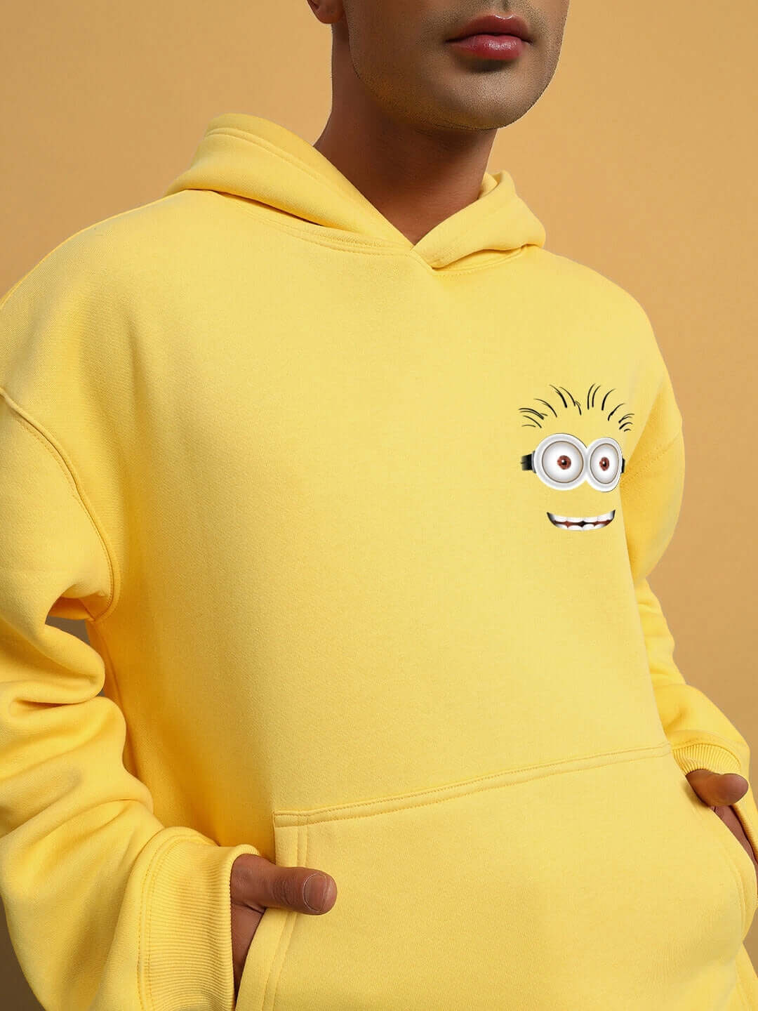 PHIL MINION OVERSIZED FLEECE HOODIE YELLOW with playful minion design on yellow fabric.