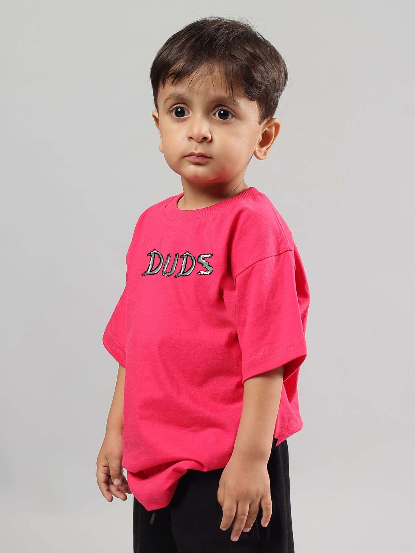 Young child wearing pink DUDS positive rabbit T-shirt, ideal for boys and girls, part of made-to-order collection with custom fit option.