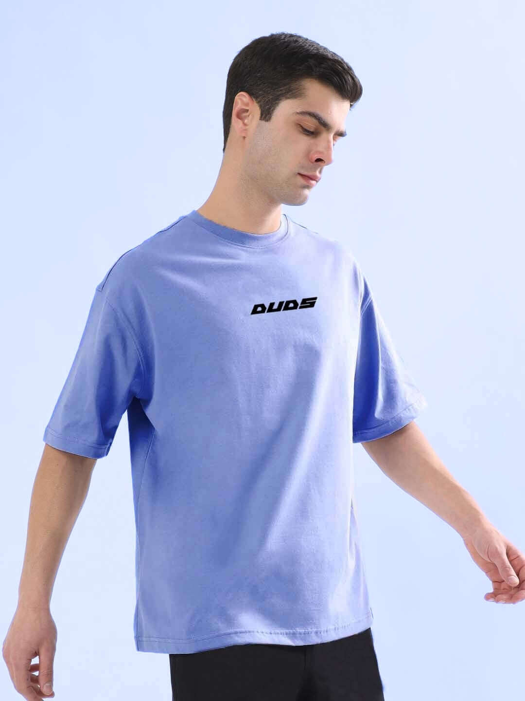 Man wearing Playboy oversized T-shirt in cobalt blue, crafted from premium cotton French terry, featuring a relaxed fit and durable fabric.
