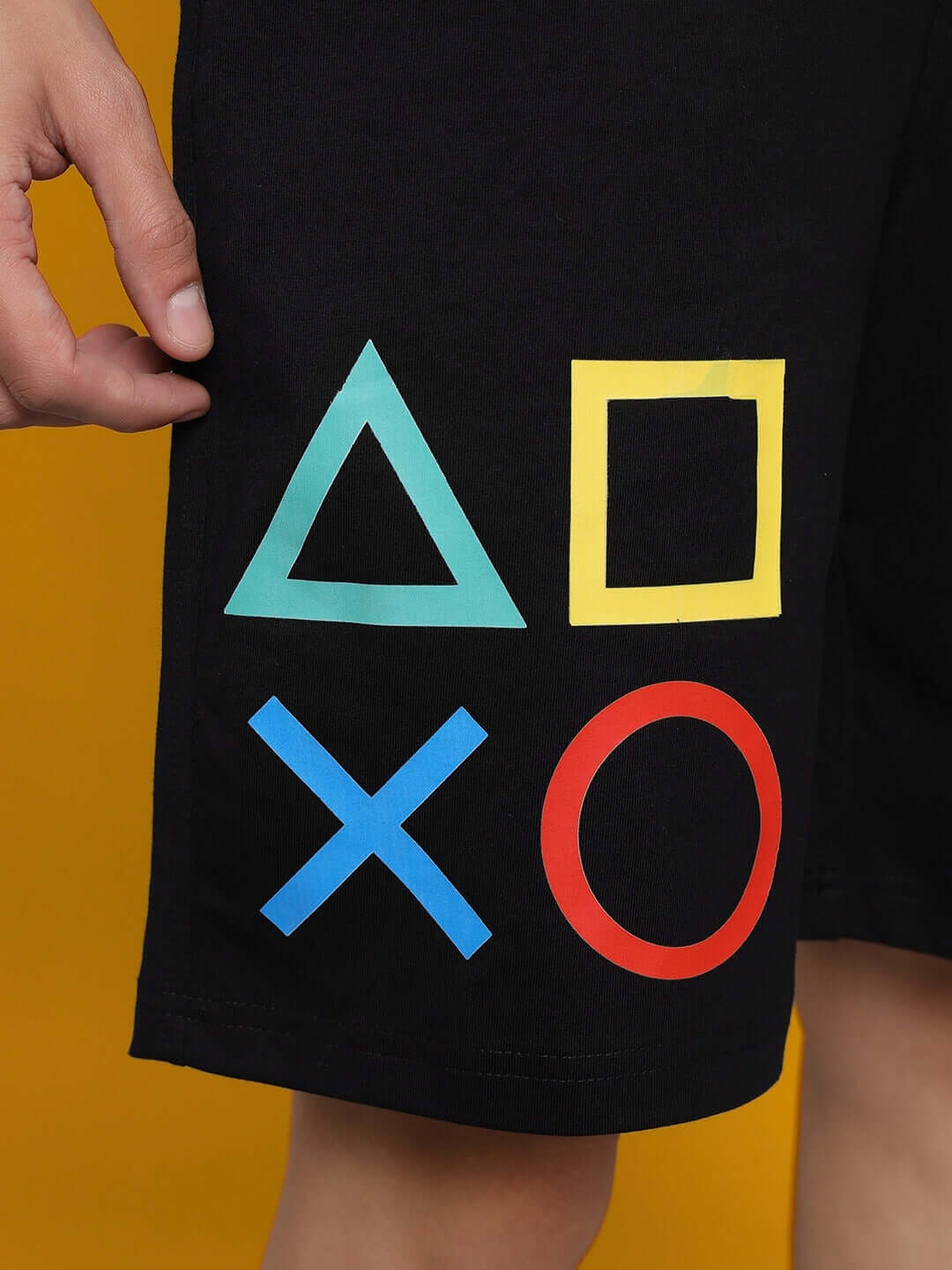 Black PlayStation shorts featuring iconic controller symbols: triangle, square, X, circle. Available in regular and custom fit.
