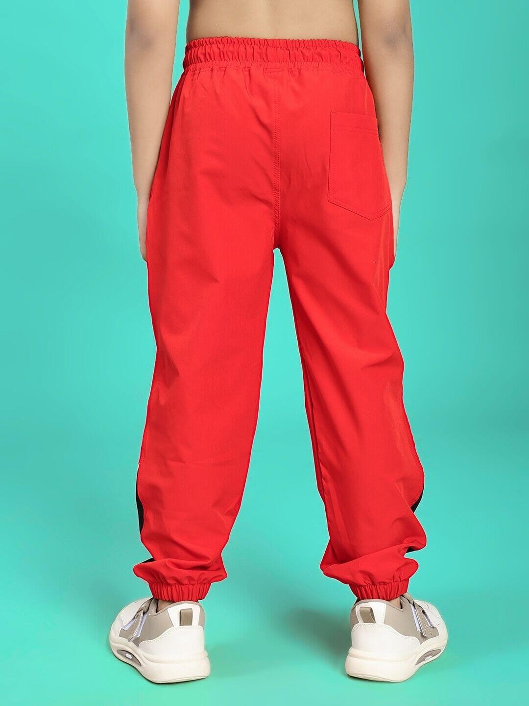 Child wearing vibrant red PLEXUS JOGGER FOR BOYS AND GIRLS RED, showcasing back view with relaxed fit and comfortable design.