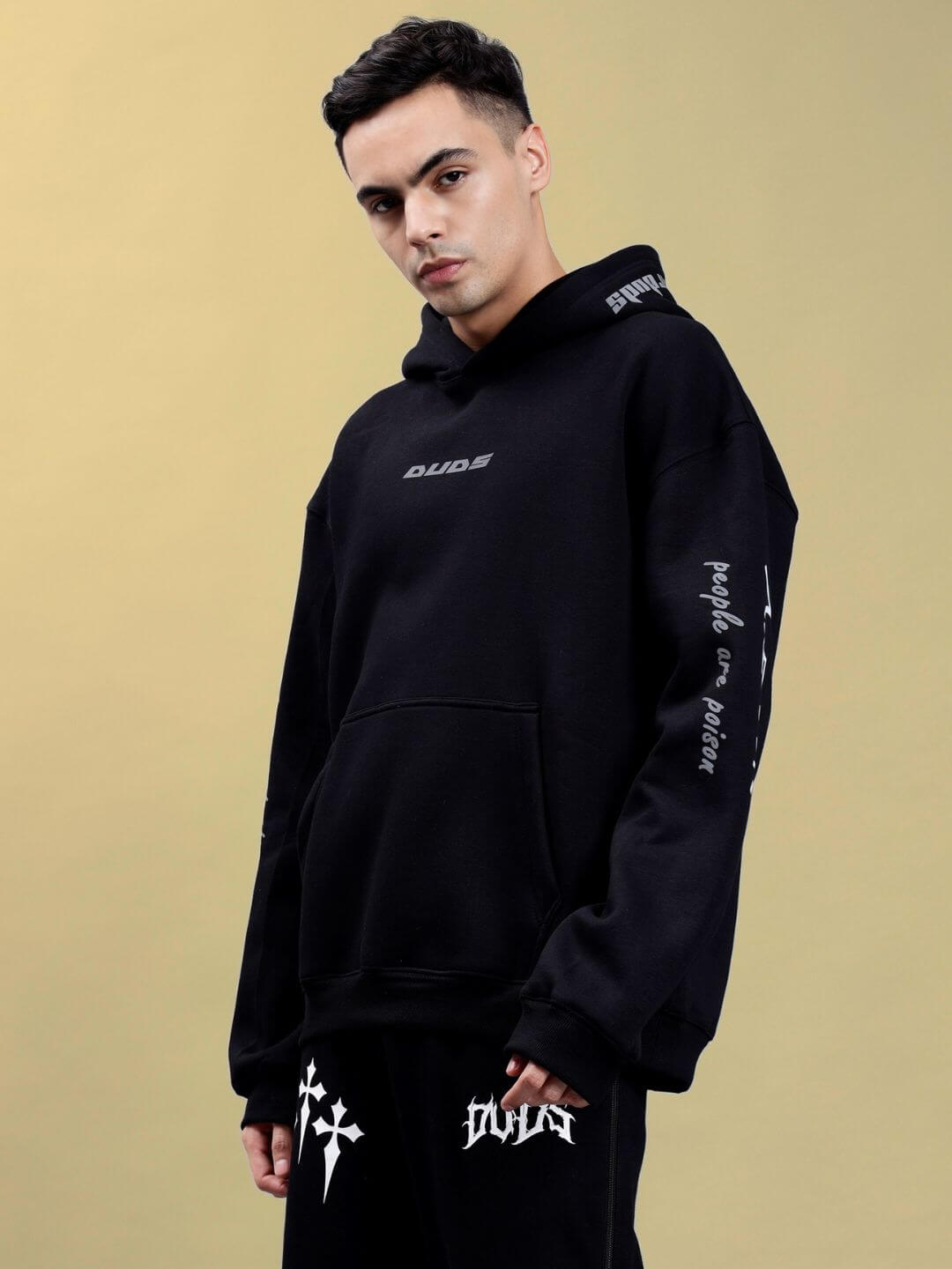 Model wearing POISON SKULL REFLECTOR OVERSIZE HOODIE BLACK showcasing bold reflective streetwear design.