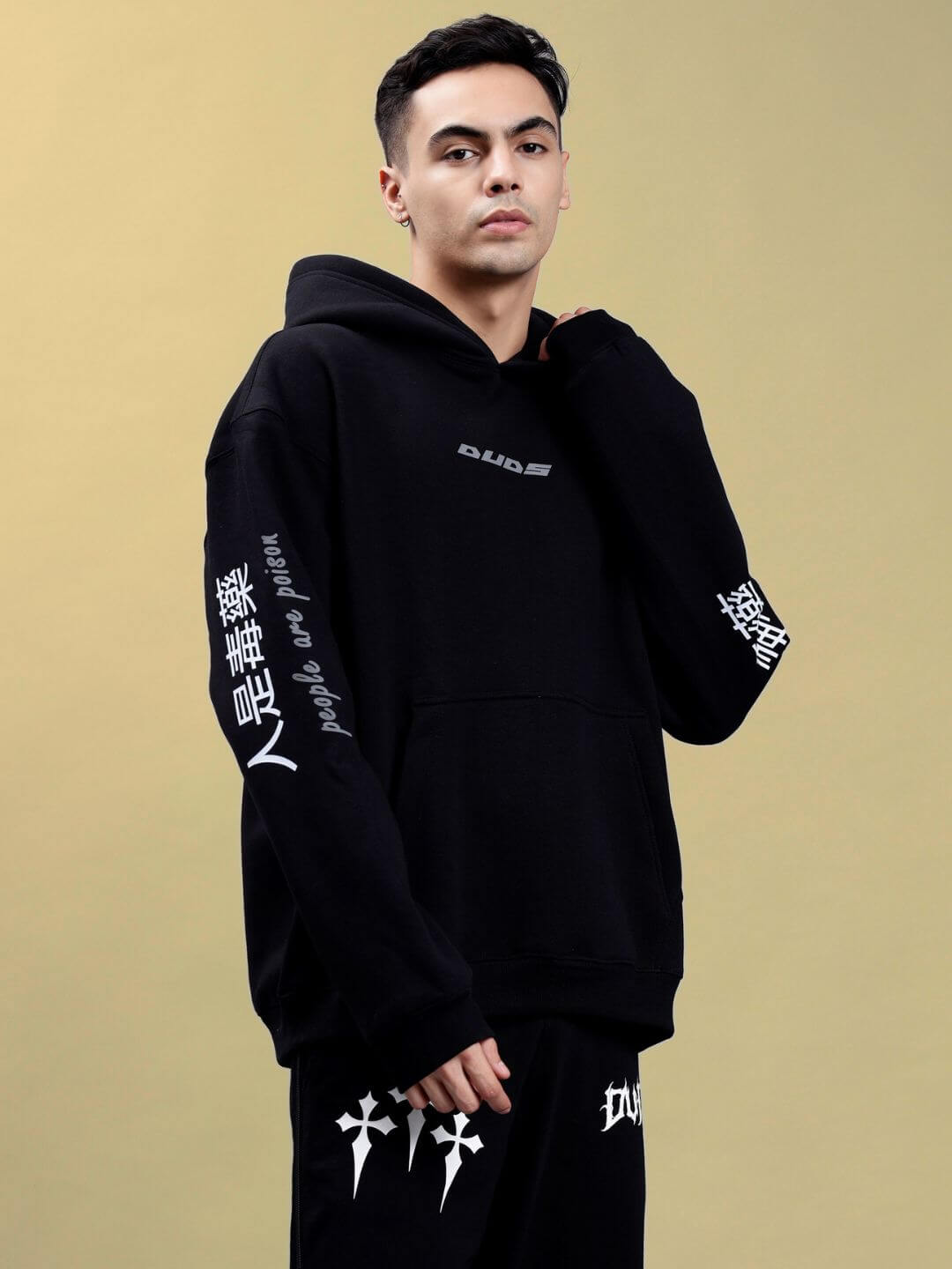 Model wearing POISON SKULL REFLECTOR OVERSIZE HOODIE BLACK with reflective skull graphic and urban streetwear style.