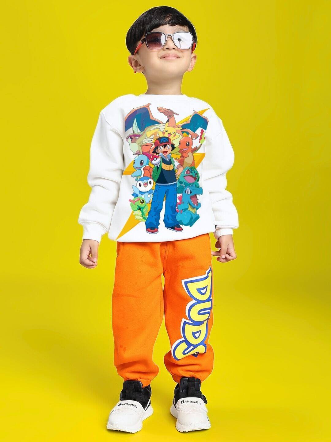 Young boy wearing POKEMON TOON FLEECE SWEATSHIRT FOR BOYS AND GIRLS OFF-WHITE with colorful Pokemon characters on a yellow background
