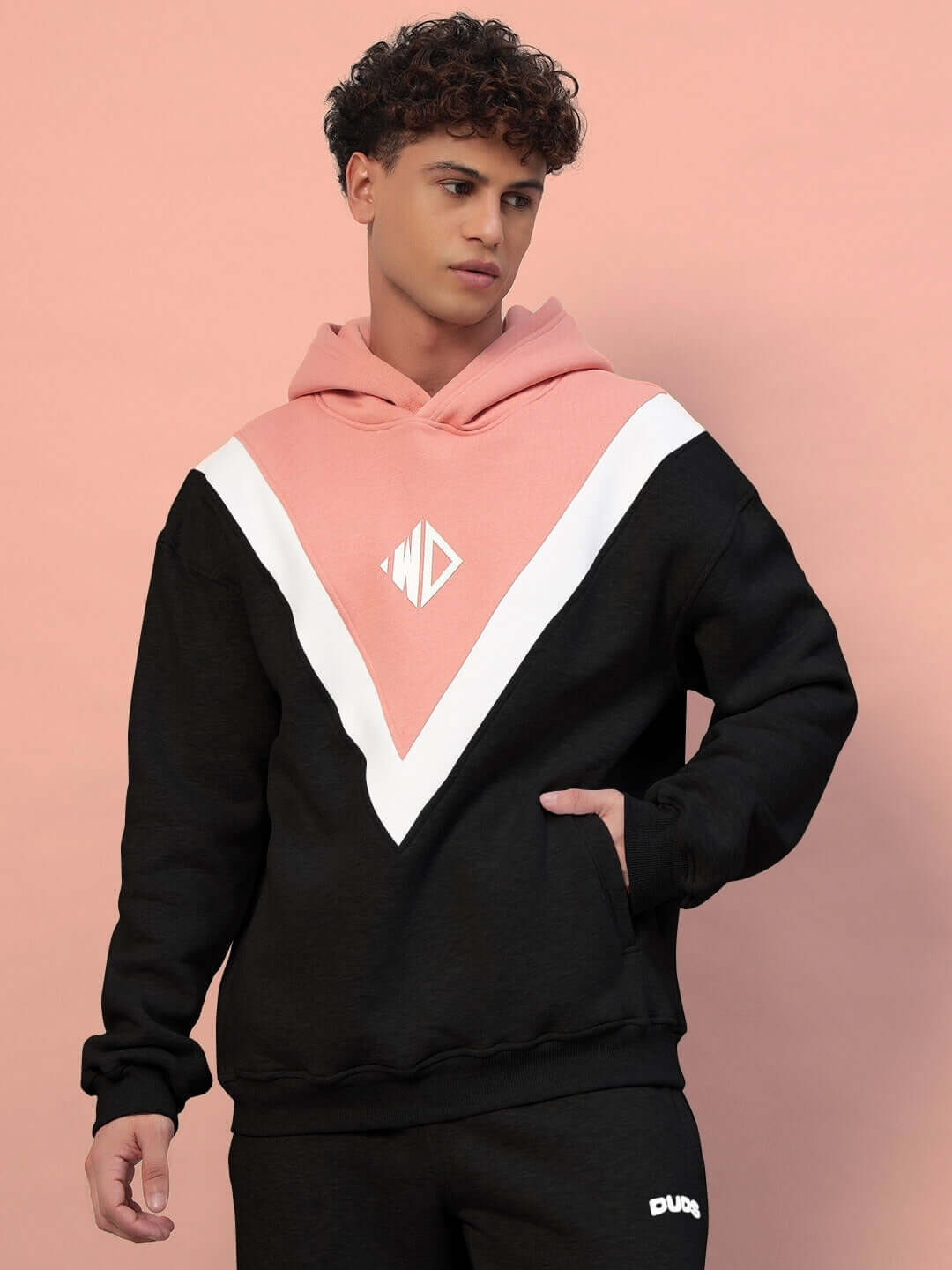 Model wearing POLAR COLORBLOCK CO-ORD BLACK PEACH with black and peach colorblock design, premium fleece for cozy streetwear style.