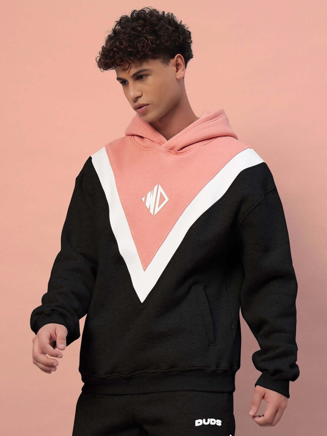 Alt Tag: Model wearing POLAR COLORBLOCK HOODIE BLACK PEACH with bold black and peach design, highlighting stylish streetwear fashion.