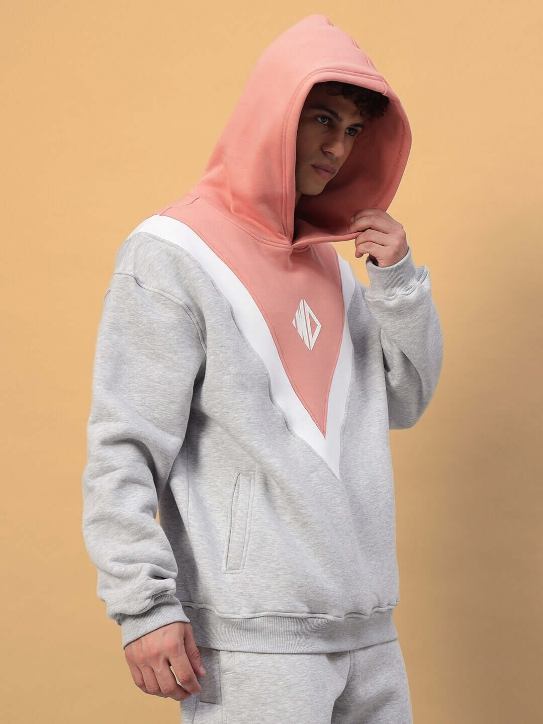 Model wearing POLAR FLEECE COLORBLOCK HOODIE GREY PEACH with peach hood and grey base.