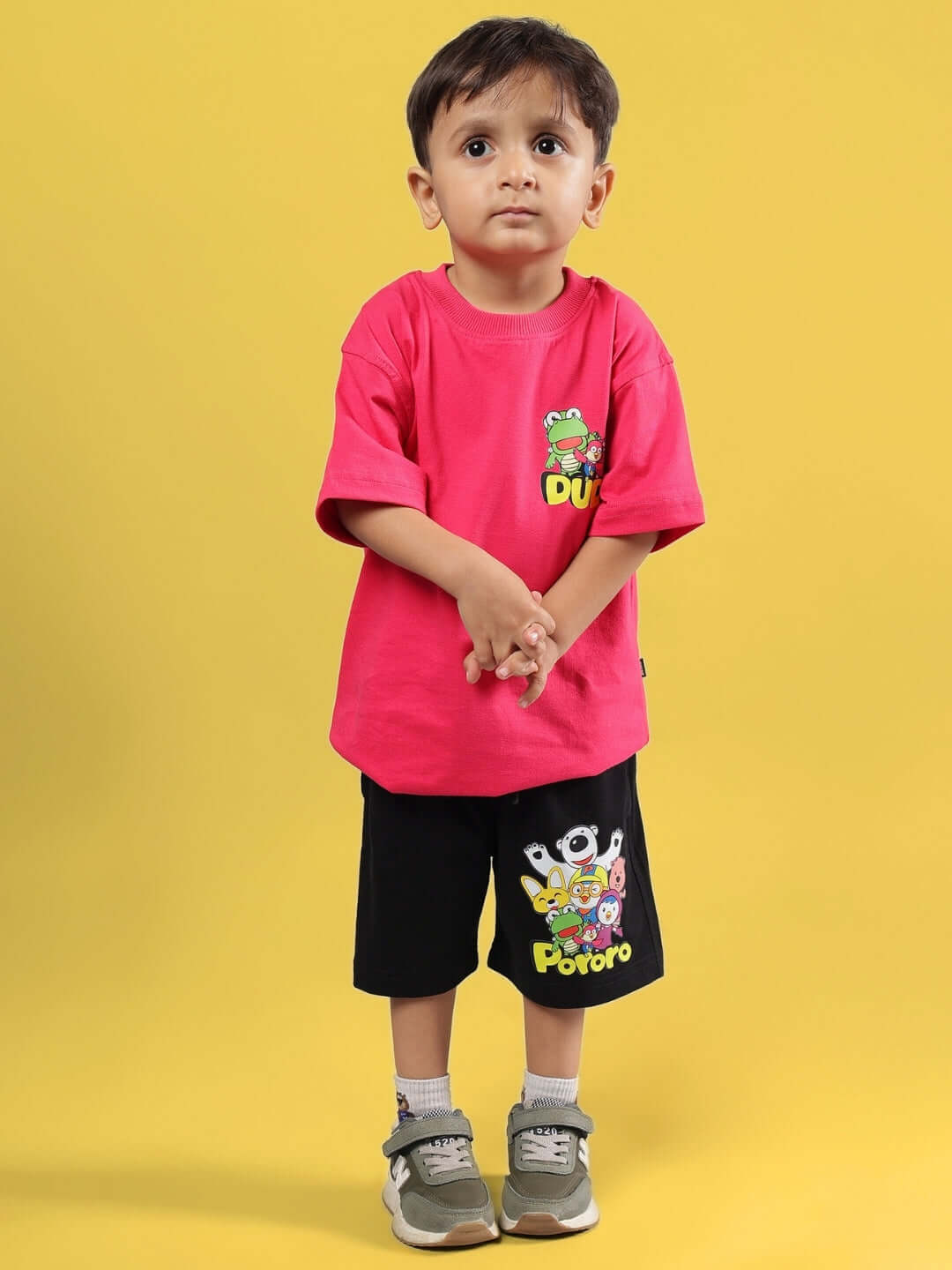 Child wearing PORORO CO-ORD FOR BOYS & GIRLS PINK-BLACK outfit against yellow background