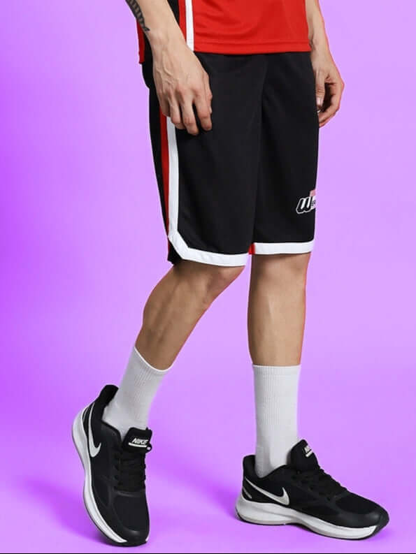 PORTIA REGULAR FIT SHORTS BLACK worn with sneakers and sports socks, showcasing sporty style and comfort.