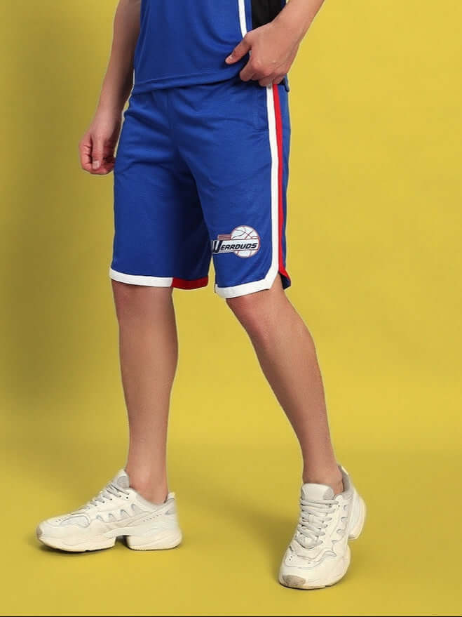 Man wearing PORTIA REGULAR FIT SHORTS ROYAL BLUE with sneakers, showcasing sporty and comfortable style for active and casual wear.