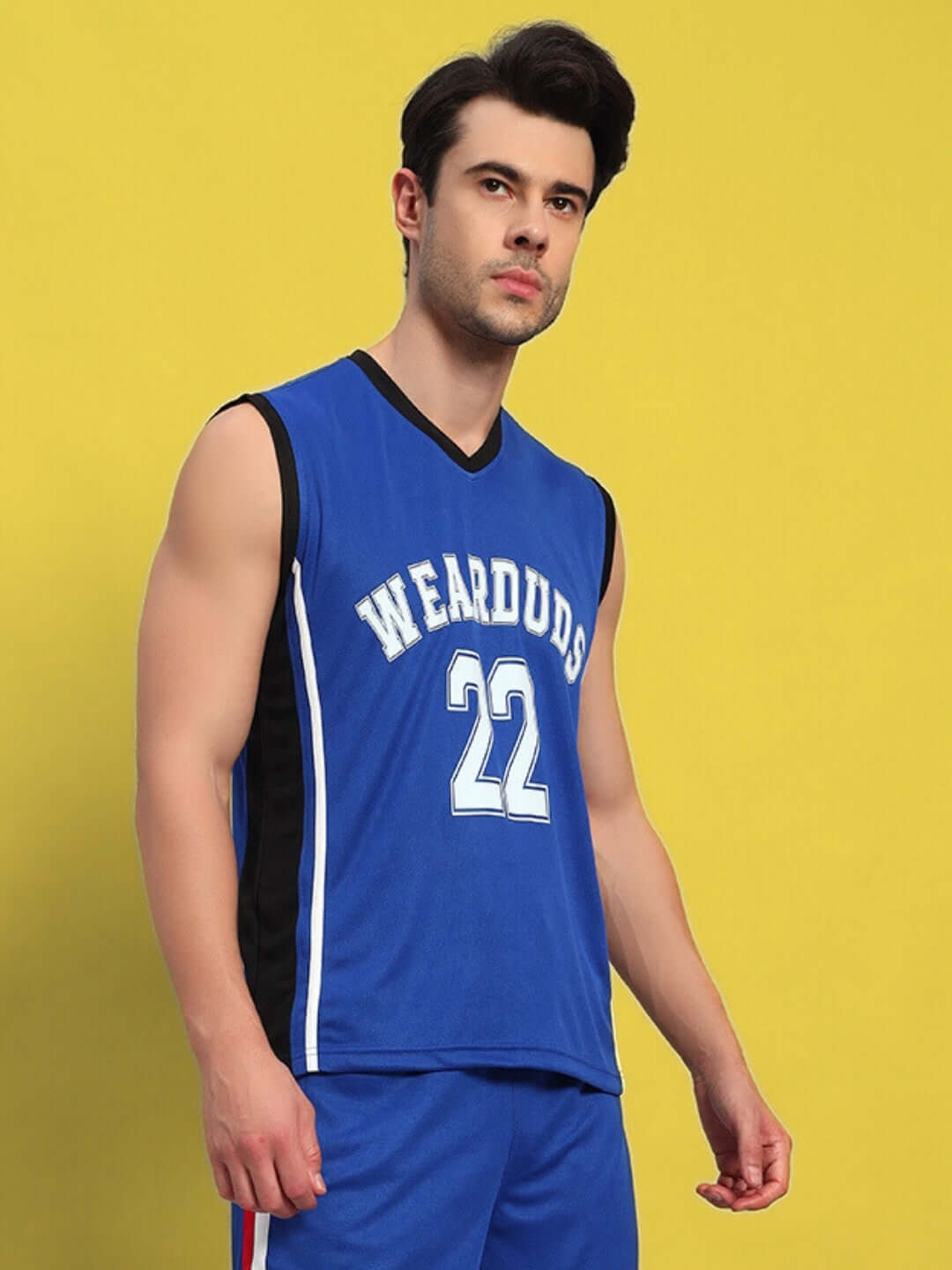 Man wearing a royal blue gym t-shirt with 'Wearduds 22' print against a yellow background.