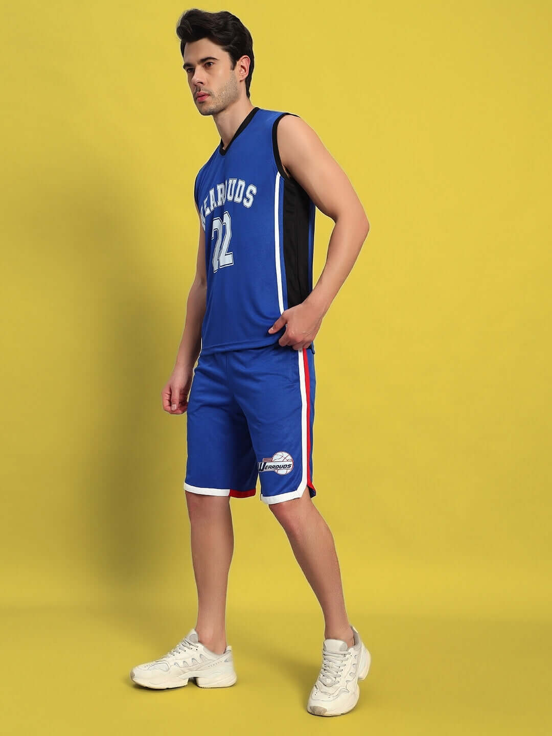 Model wearing PORTIA GYM CO-ORD SET ROYAL BLUE for workouts on yellow background.