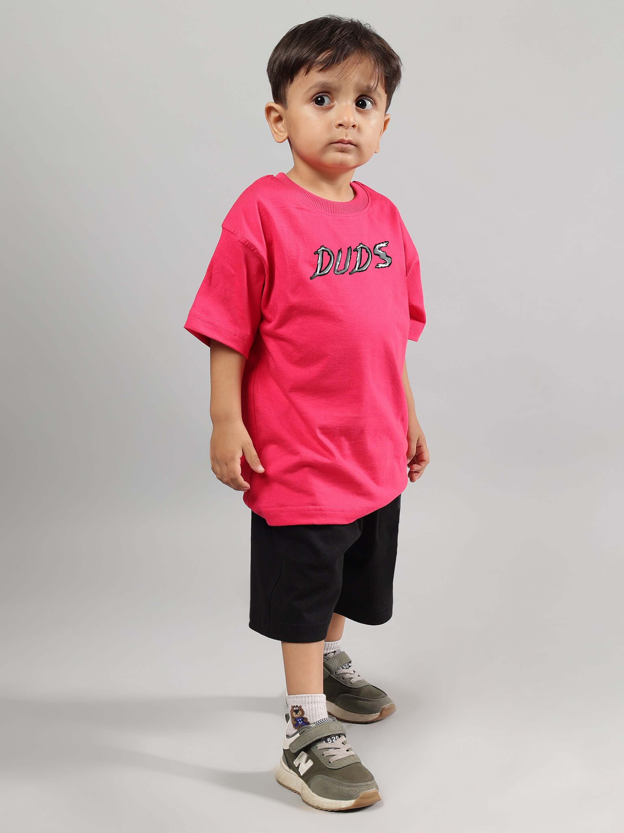 Child wearing POSITIVE RABBIT KIDS CO-ORD FOR BOYS GIRLS PINK-BLACK outfit, featuring pink t-shirt and black shorts suitable for play.