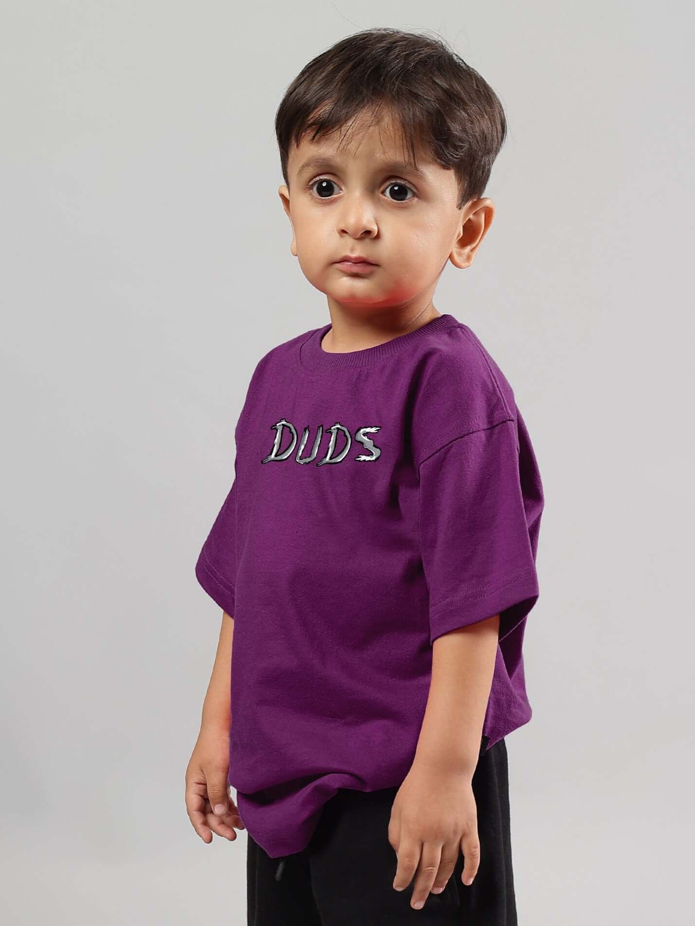 Child wearing a purple Positive Rabbit T-shirt by DUDS, designed for boys and girls, made to order with custom size options available.