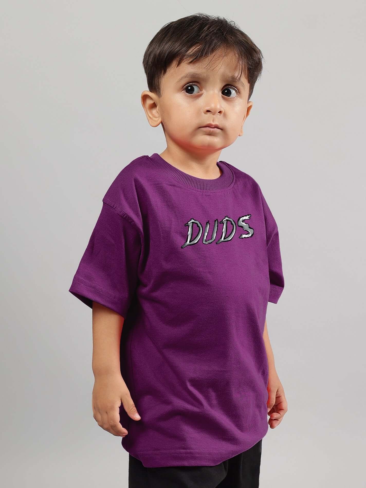 Child wearing purple Positive Rabbit T-shirt from DUDS, showcasing unisex style for boys and girls.
