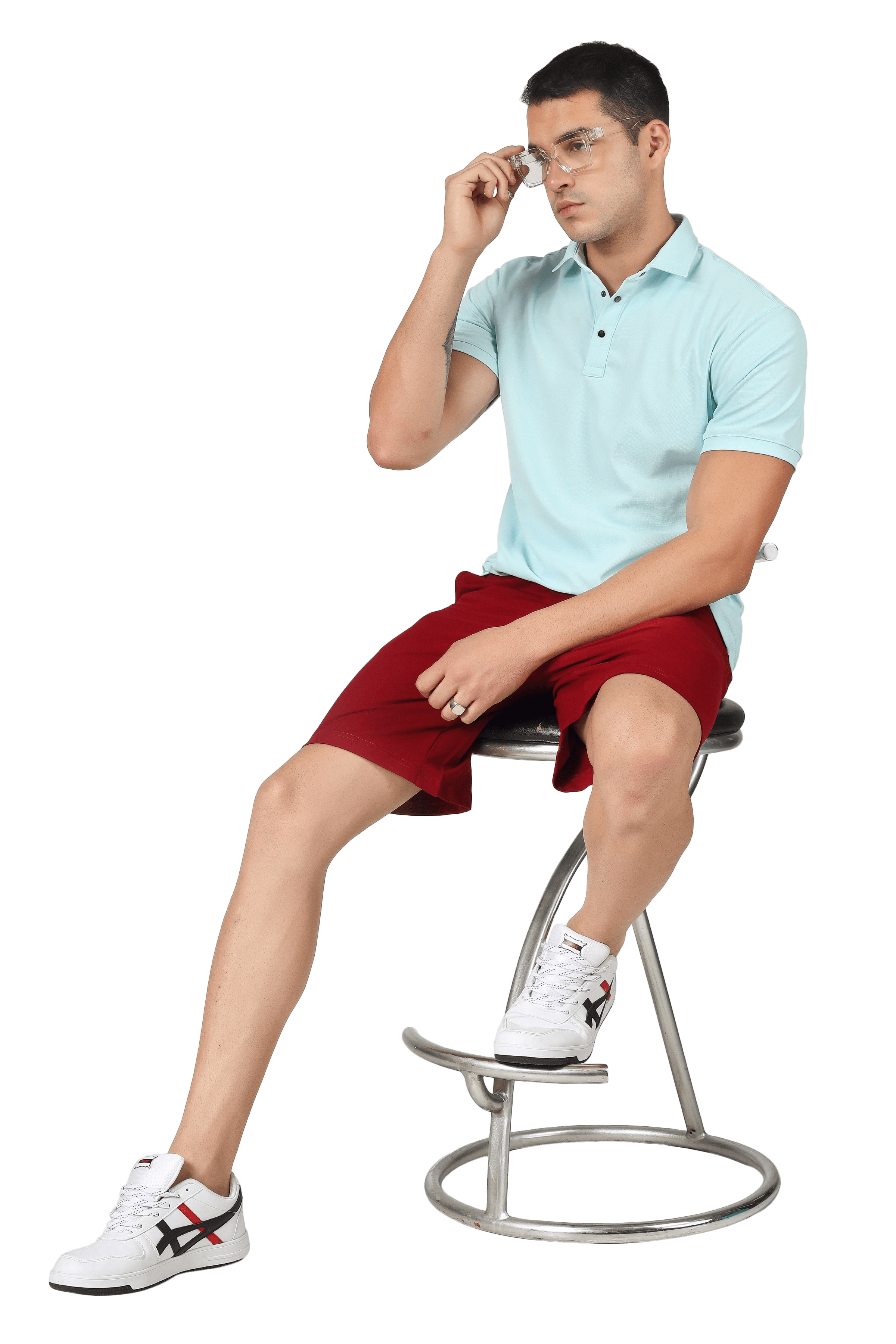 Man wearing powder blue polo neck t-shirt with red shorts, seated, highlighting sporty style and comfort, ideal for casual occasions.