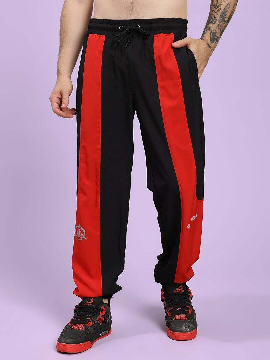 POWER BLOCK CO-ORD SET BLACK RED Black and red track pants worn by a person on a light purple background