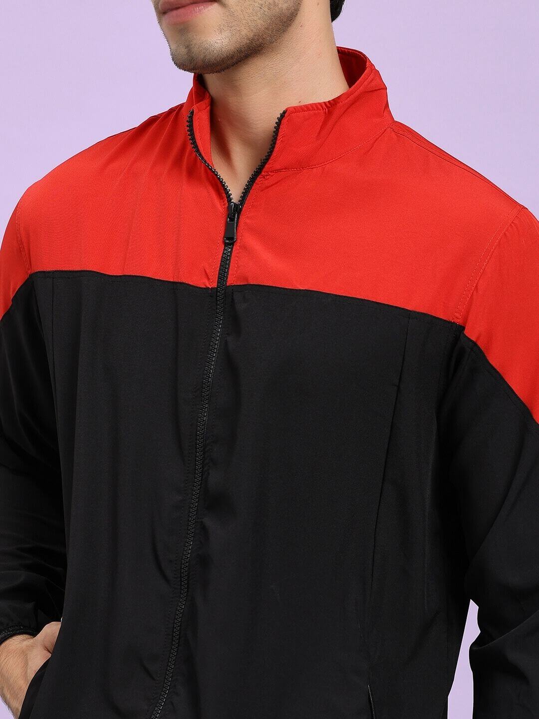 POWER BLOCK RELAXED FIT JACKET BLACK RED Red and black jacket worn by a person on a light purple background