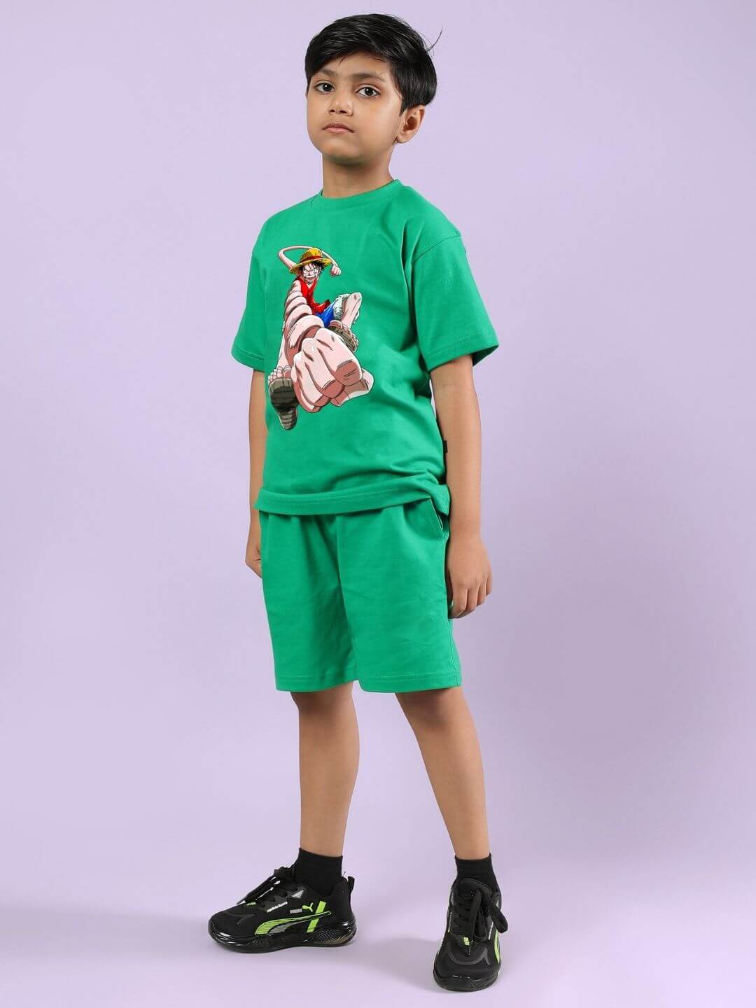 Child wearing Power Punch Co-Ord Set in Green, featuring a graphic tee with shorts, perfect for boys and girls, styled with black sneakers.