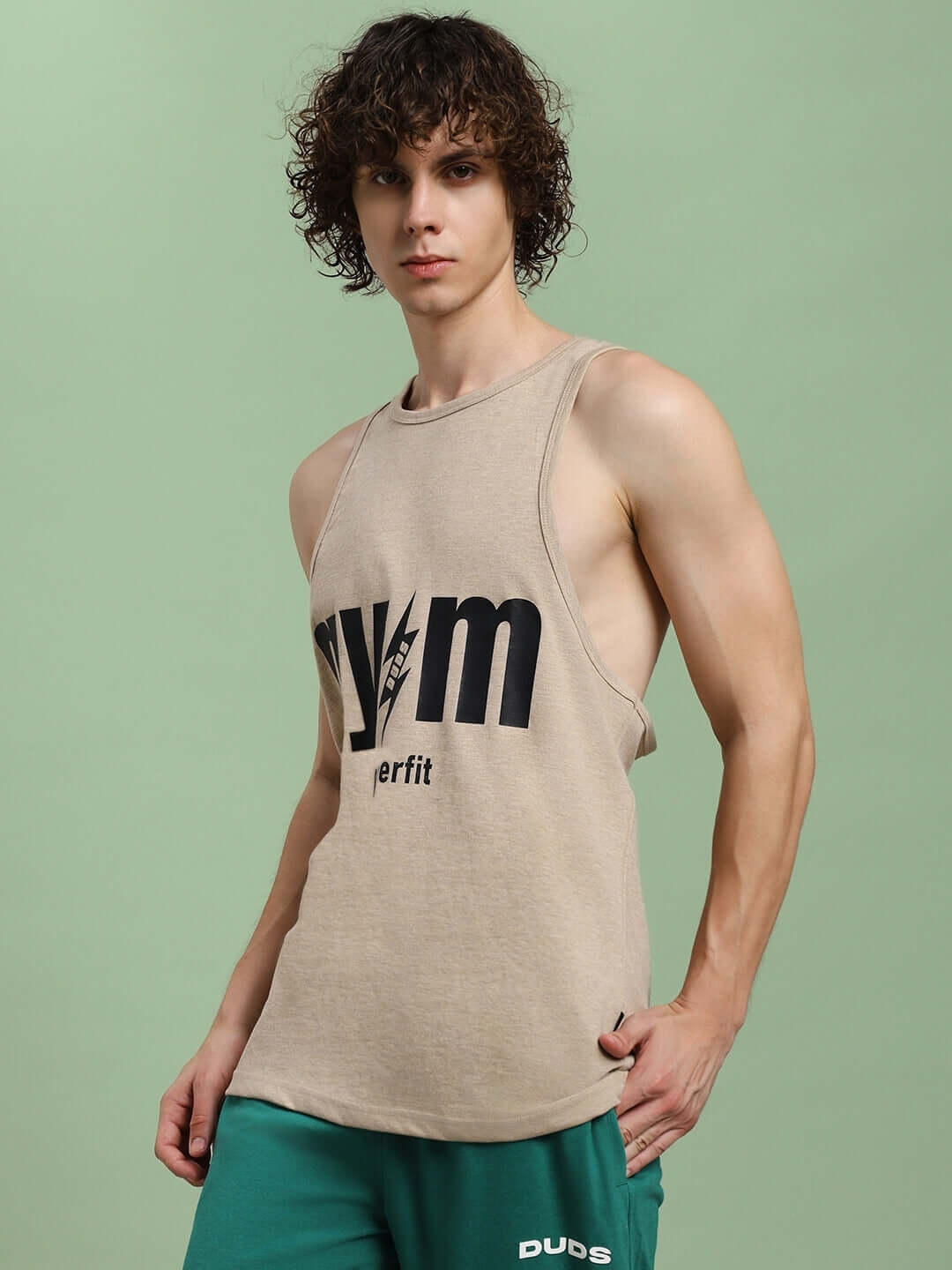 Man wearing PowerFit fitness gym t-shirt in beige, showcasing athletic cut with bold logo branding on the front.