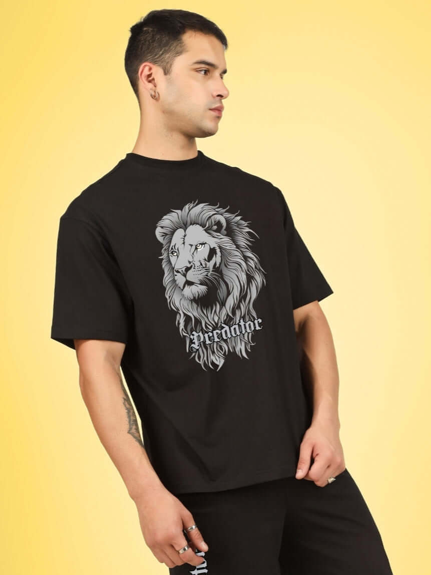 Model wearing PREDATOR LEGND PRINTED T-SHIRT BLACK with a bold lion graphic, showcasing street-ready style.