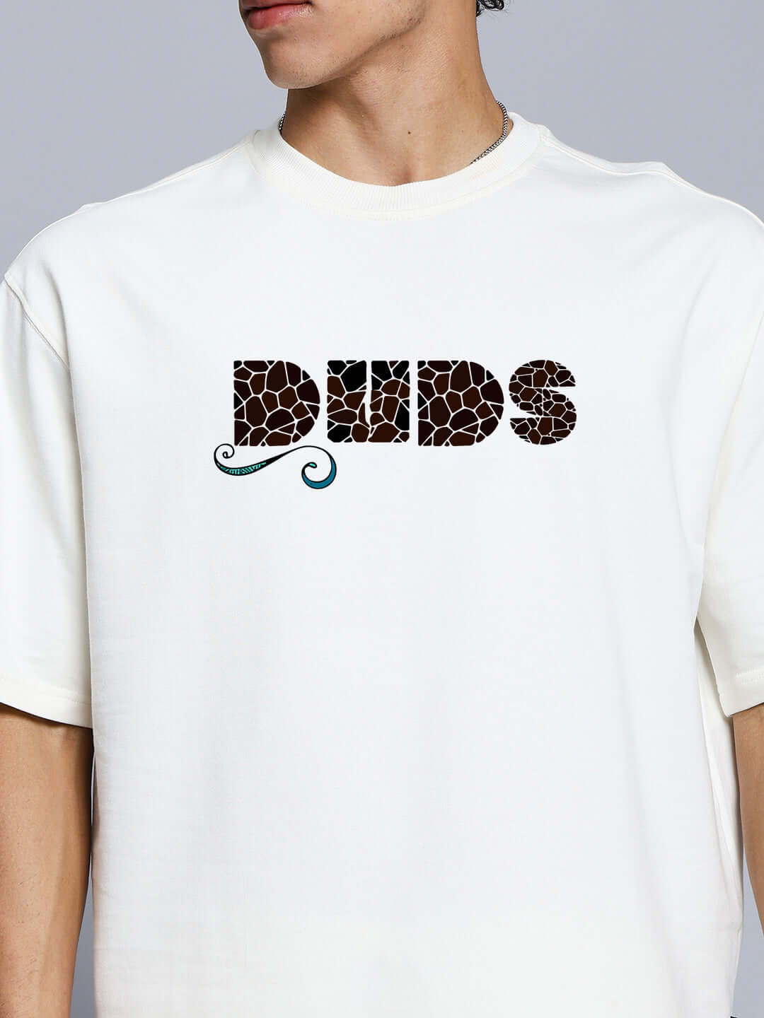 Man wearing premium fish print oversized t-shirt in off white, featuring a bold design on premium cotton fabric.