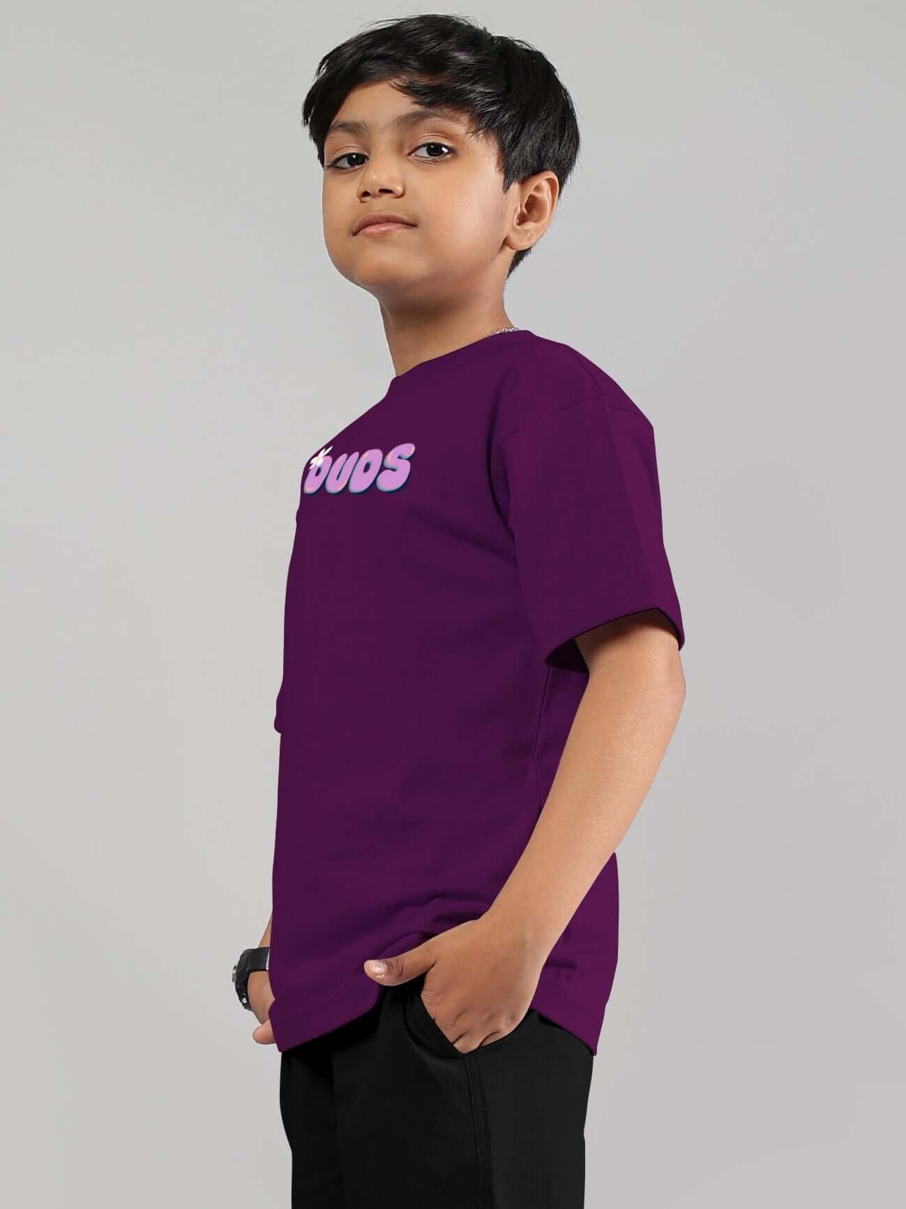 Young boy wearing purple 'NO POS WOW' DUDS t-shirt, tailored for boys and girls, customizable fit available.