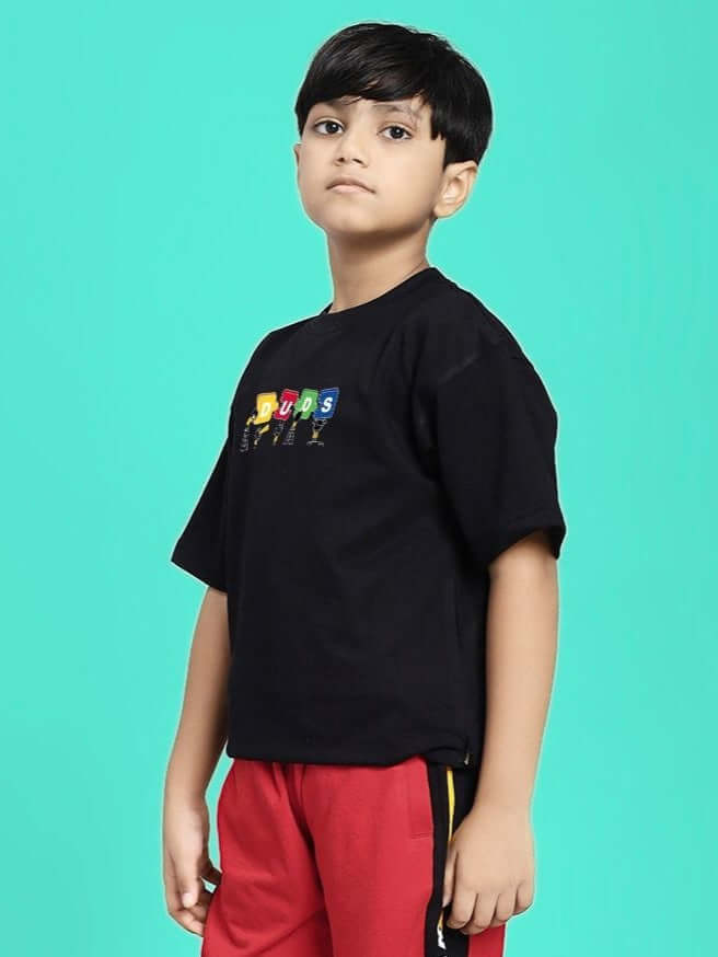 PUZZEL T-SHIRT FOR BOYS AND GIRLS BLACK worn by boy standing against teal background