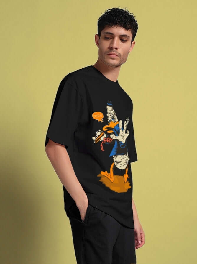 Model wearing QUACK OFF OVERSIZED T-SHIRT BLACK with bold graphic in relaxed fit