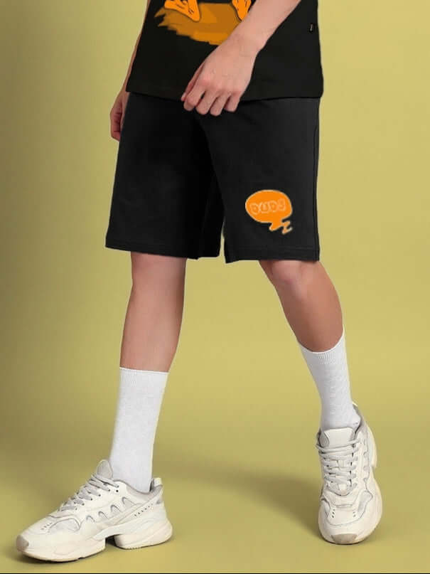 Person wearing QUACK OFF SUMMER COTTON SHORTS BLACK with "Quack Off" graphic, perfect for stylish summer wear.