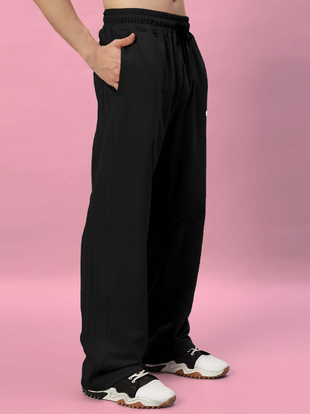 Man wearing Quantum Relaxed-Fit Joggers in black, featuring a casual style with an elastic waistband, suitable for custom-fit orders by DUDS.