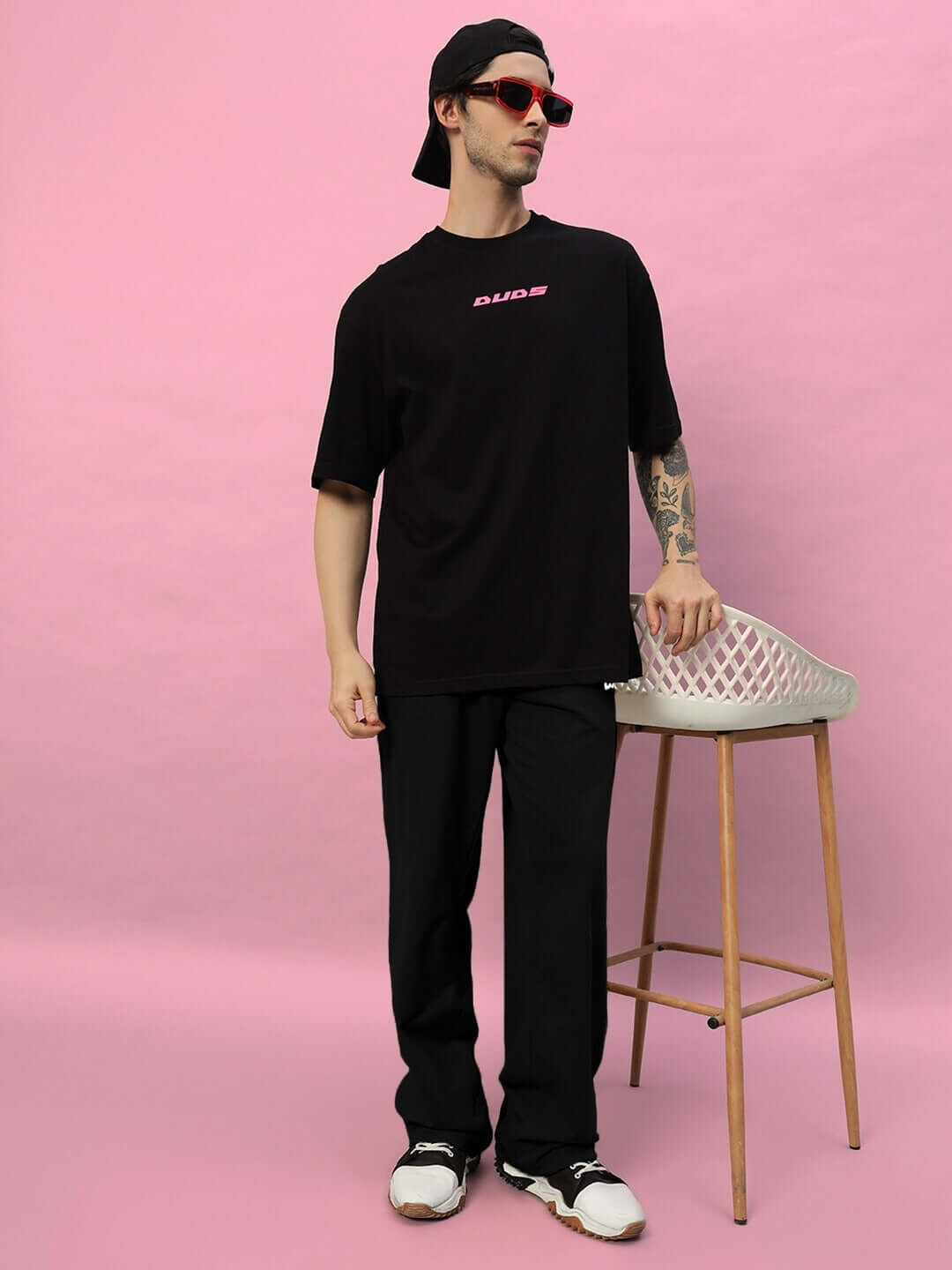 Man wearing Quantum Relaxed-Fit Joggers in black, paired with a casual tee, showcasing a laid-back style ideal for comfort and fashion.