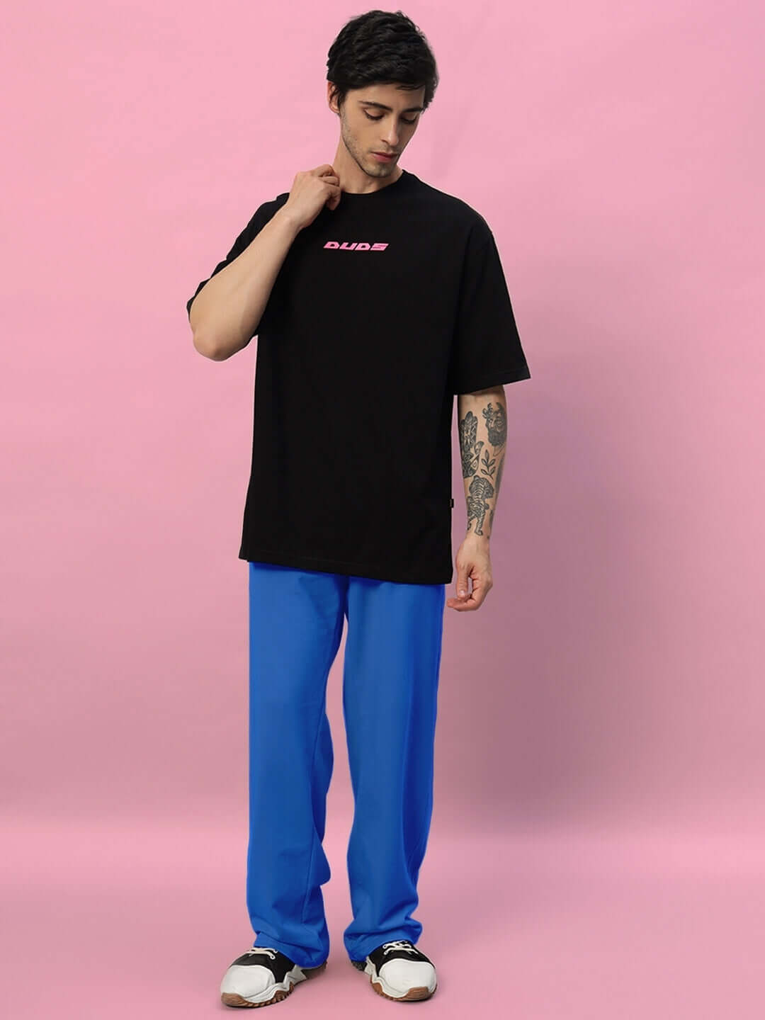Model wearing Quantum Relaxed-Fit Joggers in royal blue, paired with a black tee, showcasing comfortable, custom-fit style by DUDS.