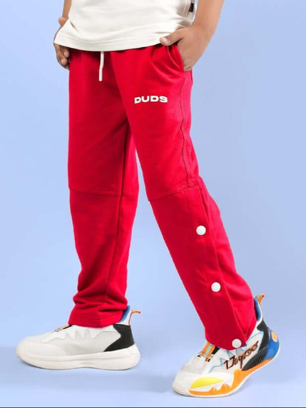 RACER JOGGER FOR BOYS & GIRLS RED featuring white sneakers and button detail, perfect for kids fashion.