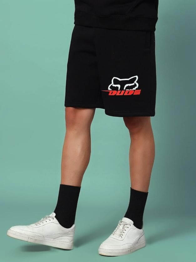 Person wearing RACING FOX FLEECE SHORTS BLACK with racing-inspired graphic design, ideal for comfort and streetwear style.