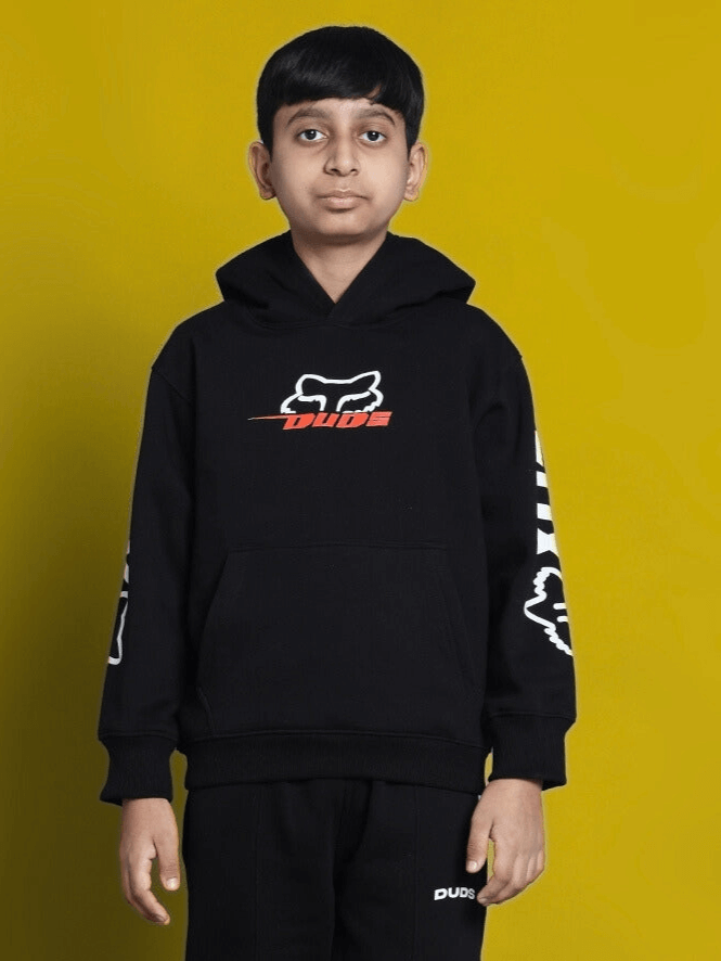 Boy wearing black RACING FOX oversized hoodie with logo, suitable for boys and girls. Casual streetwear fashion for kids.